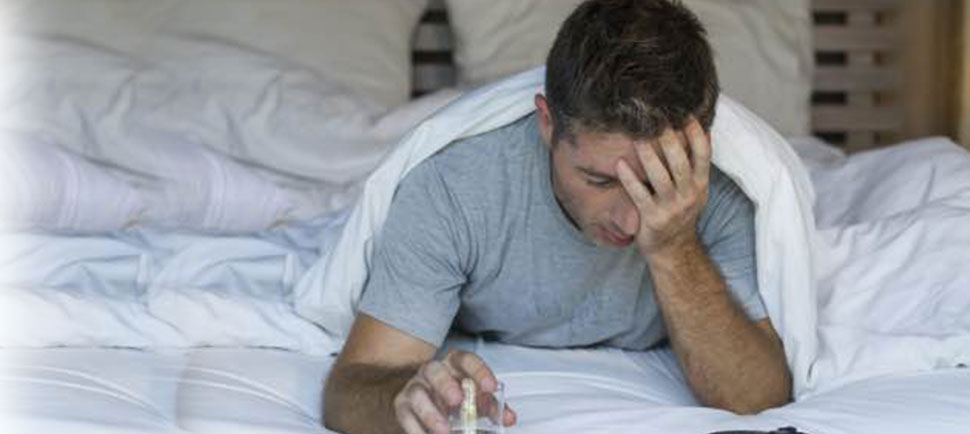 man in bed exhibiting effects of alcohol abuse