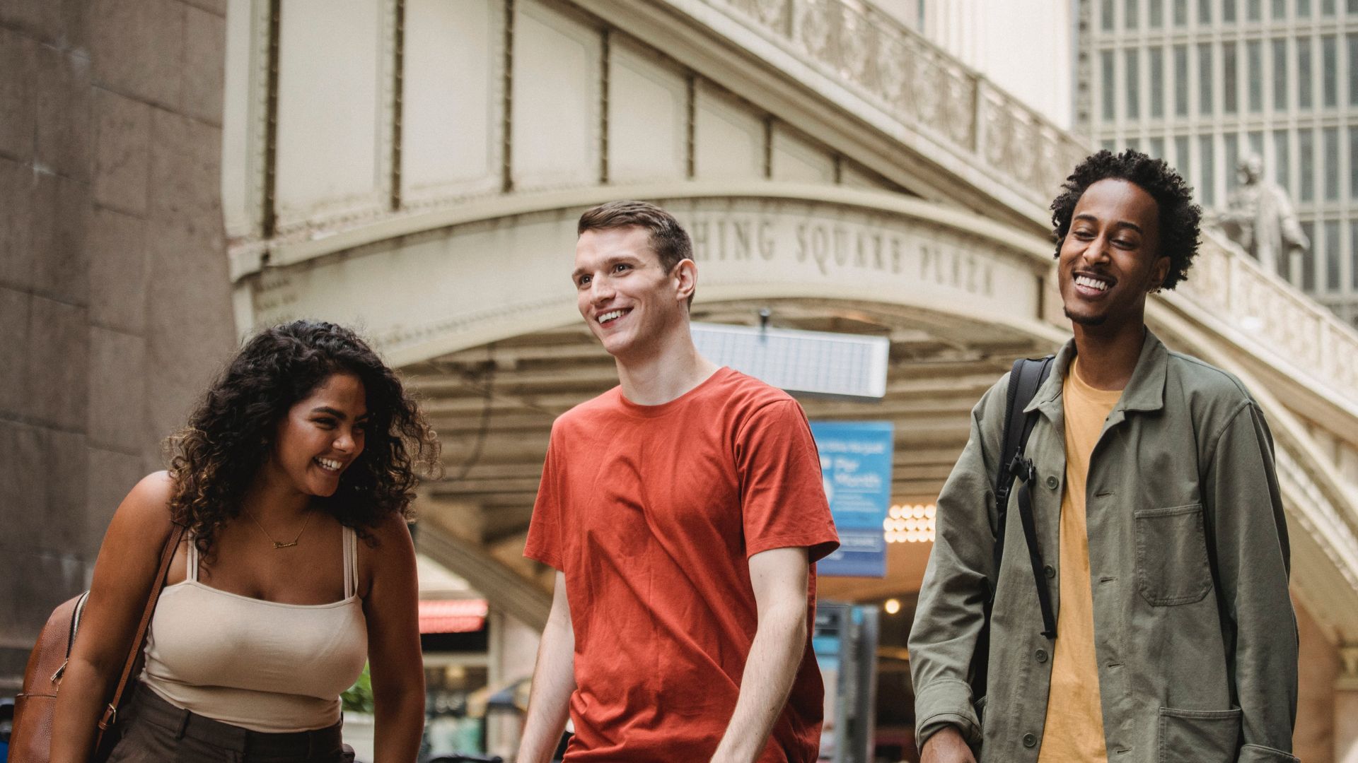 a photo of happy group of friends on the street