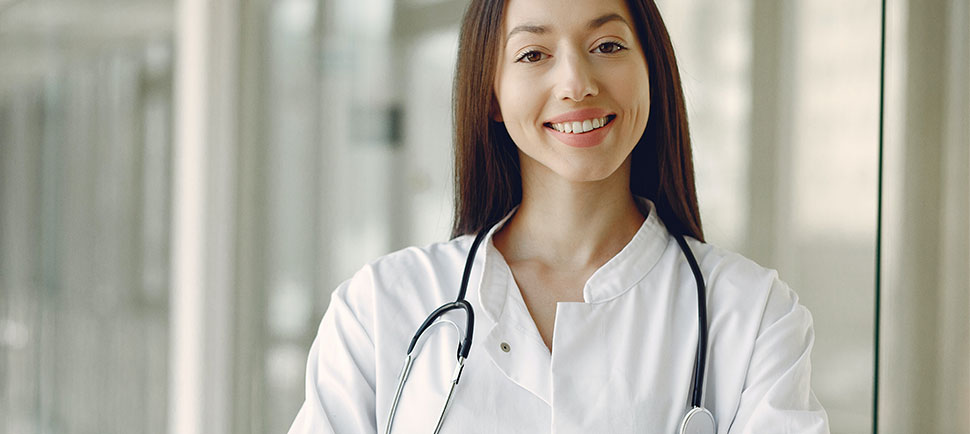 photo of medical staff with stethoscope standing in treatment center corridor