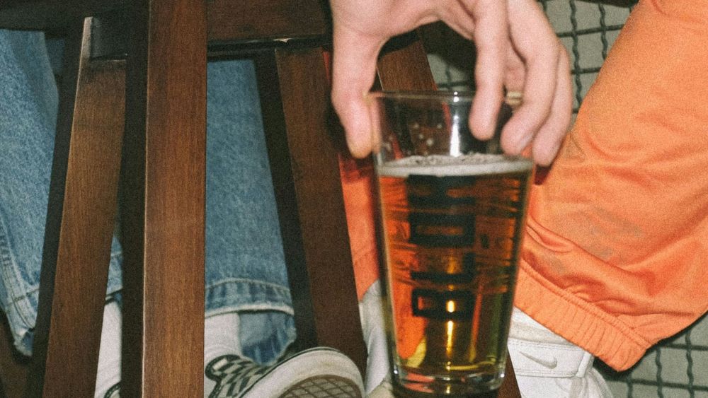 person holding a glass of alcohol