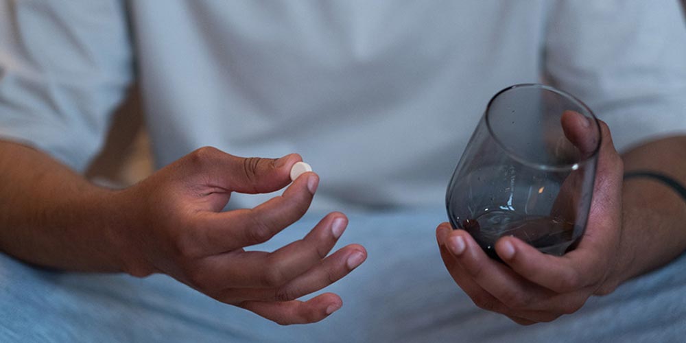 photo-of-a-man-holding-a-pill